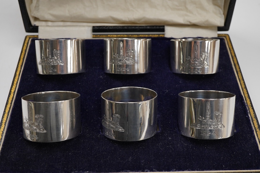A cased set of six George V Irish silver napkin ring's, each engraved with a dear and harp on a rocky mound with tower and dated 1924, Wakely & Wheeler, Dublin, 1923.